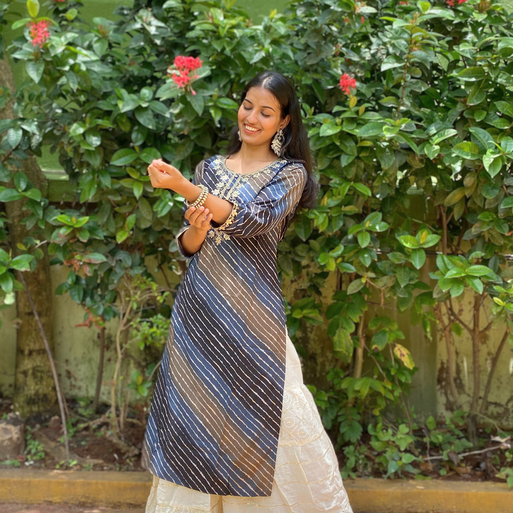 
                      
                        Shades Of Navy Blue and Brown Leheriya Kurta with Gota Pati Work
                      
                    